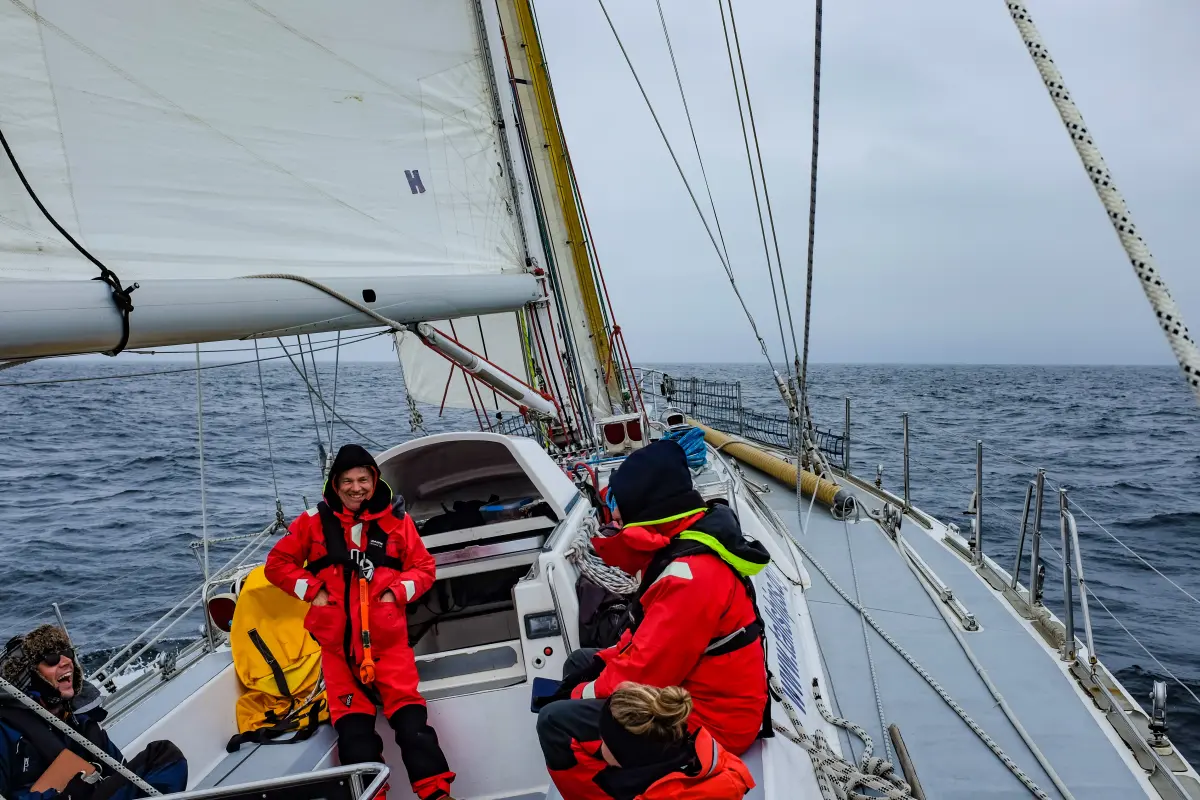 Crew on deck crossing the North Sea from Portsmouth to Norway under a cloudy sky