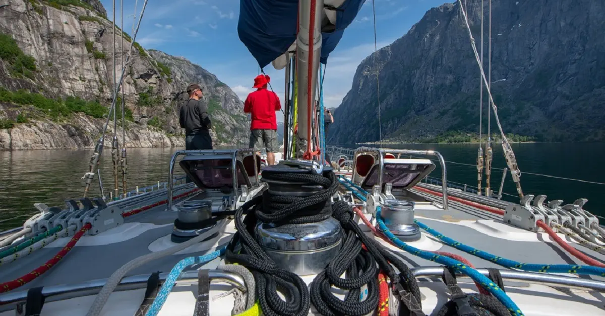 Sailing the Hitchhiker’s Guide Norwegian fjords beneath towering mountain walls